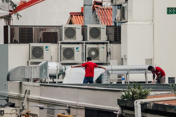 A couple of men on a roof 600 Unsplash