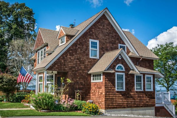 Brown brick house with a flag Unsplash