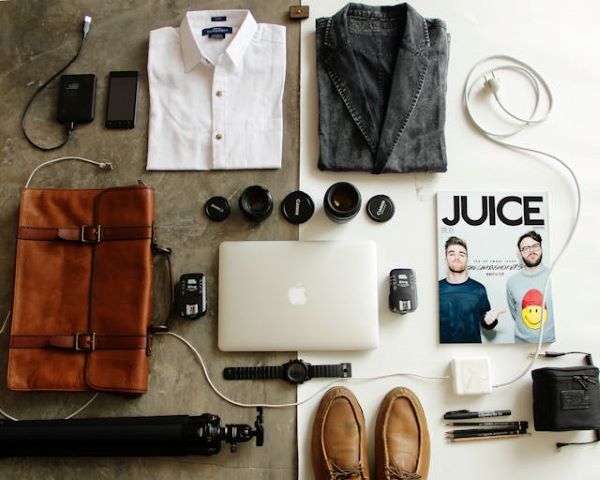 Brown leather bag clothes and macbook 600 Pexels