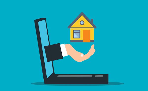 Hand from laptop holding a house 600 Pixabay