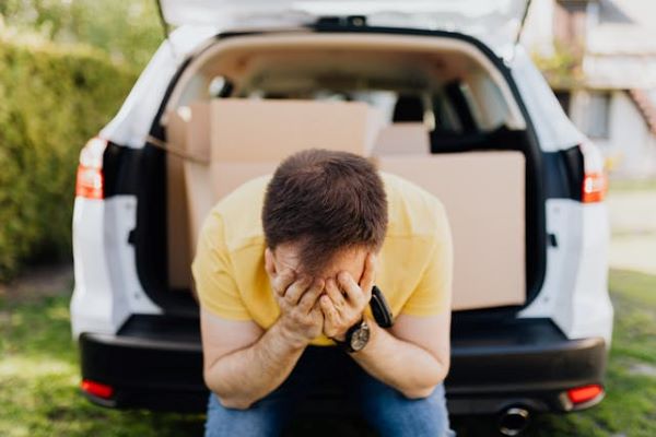 Man covering face with hands near car trunk 600 Pexels