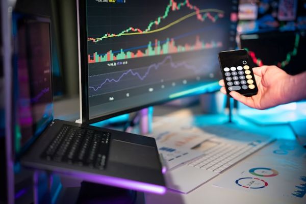 Person holding a calculator in front of a computer 600 Unsplash