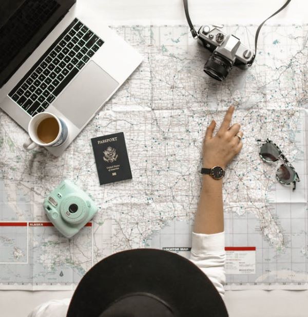 Person pointing to a location on a map 600 Pexels