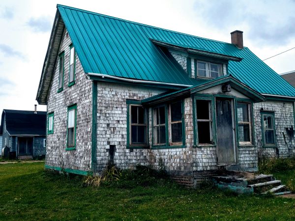 White brick house with green roof 600 Unsplash