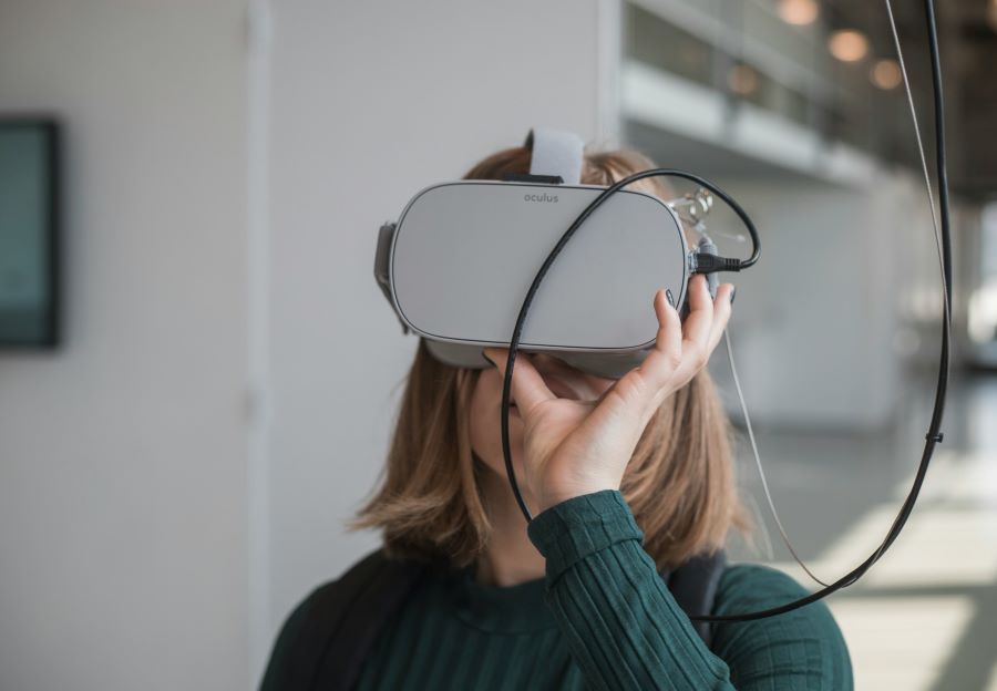 Woman holding VR glasses Unsplash