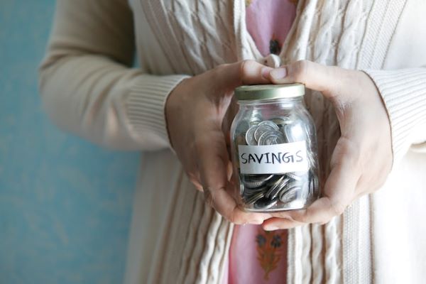 Woman holding coin jar