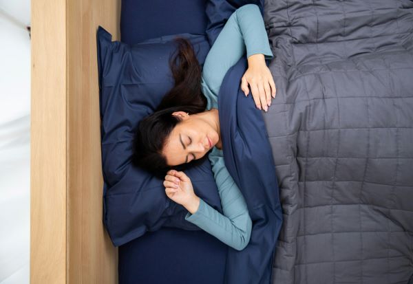 Woman sleeping with weighted blanket1 Unsplash