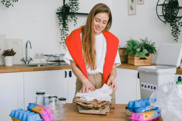 Woman stacking paper Pexels