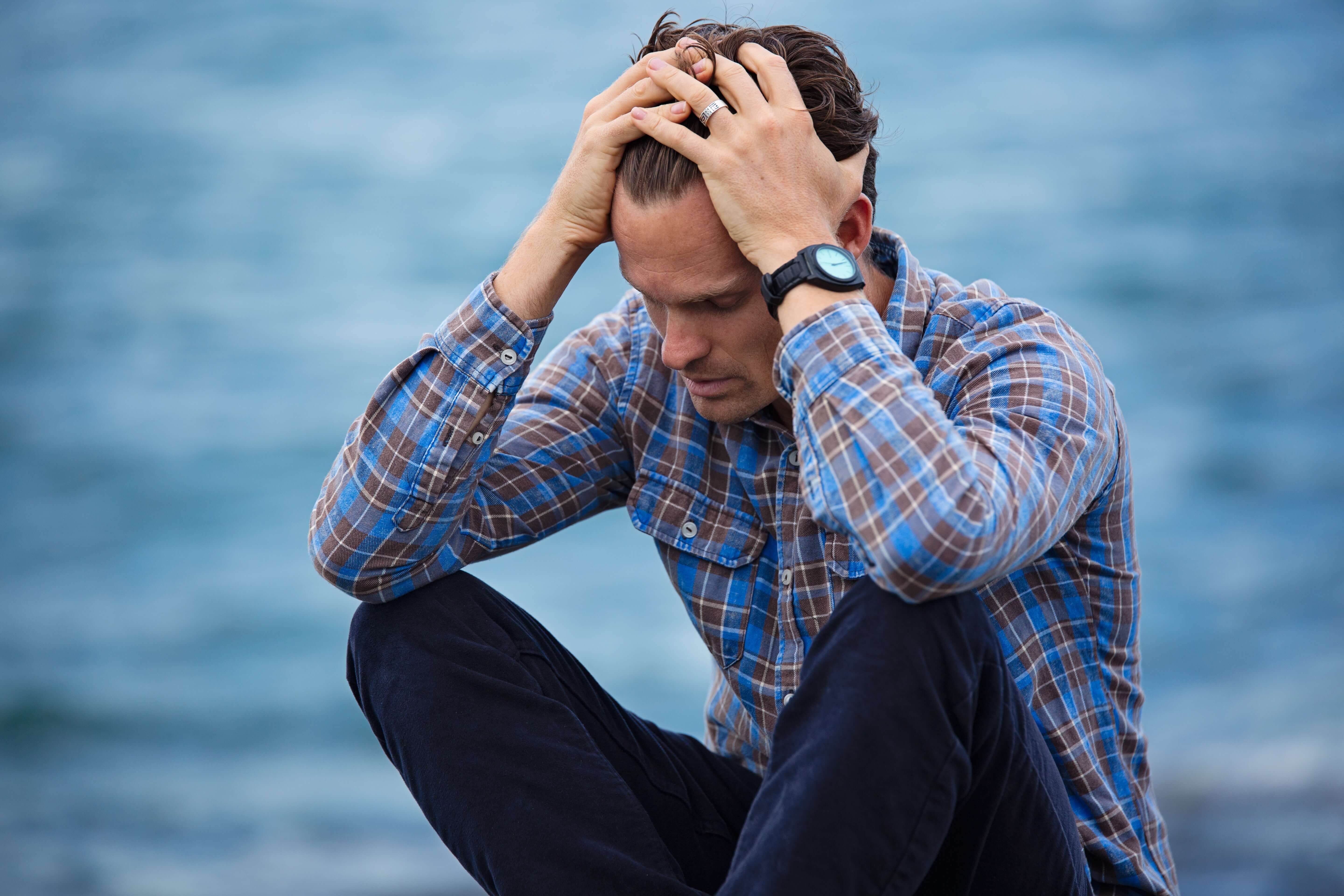 man-in-blue-and-brown-plaid-dress-shirt-touching-his-hair-897817-2.jpg