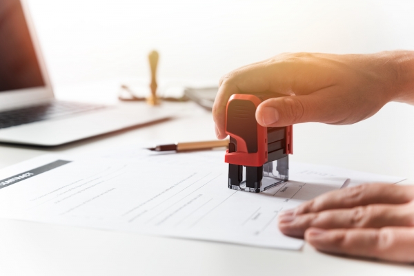 What is the process of verifying the signer for a real estate transaction?